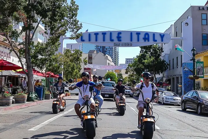 a group of people riding motorcycles on a city street