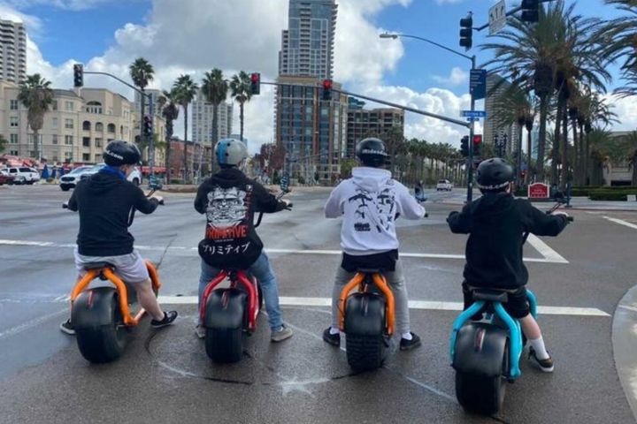 a group of people riding motorcycles on a city street